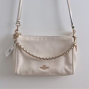 Coach Carrie Crossbody Bag in Pebble Leather Ivory with chain. NWT.